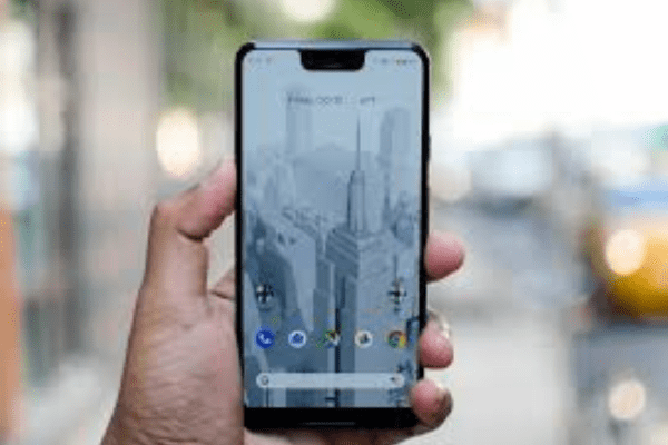 a person has Google Pixel 3XL in his hand with building wallpaper
